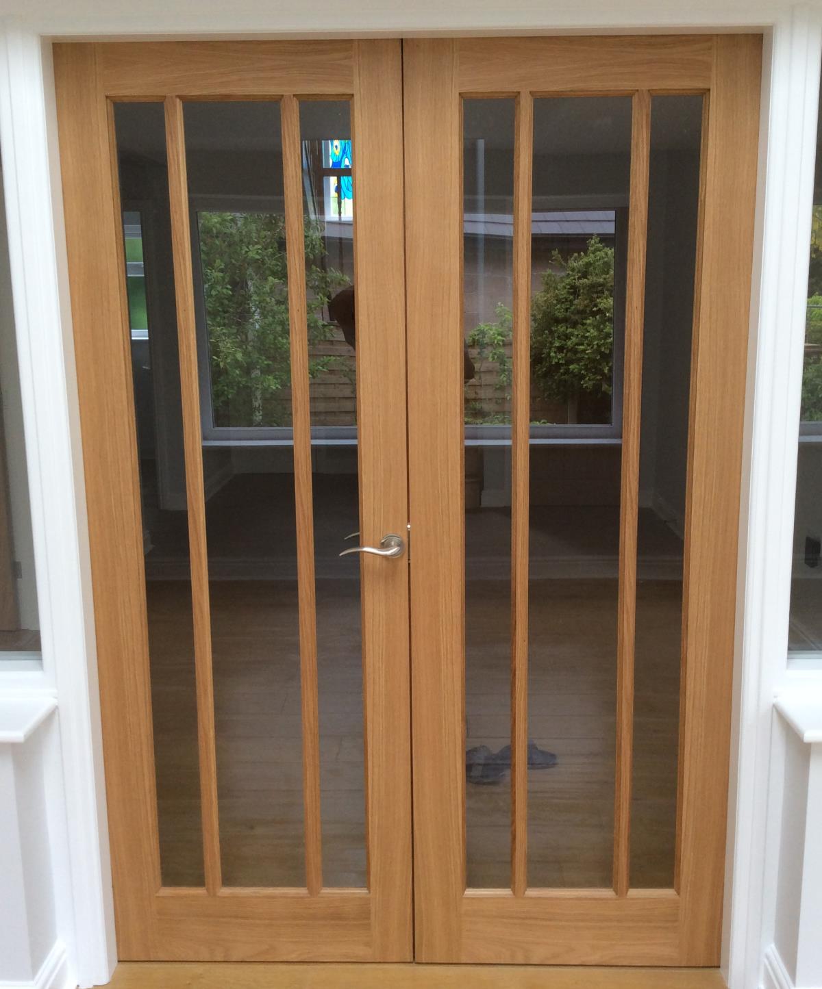 New interior doors to open walk-through including glass and framework in Arnside. Photo - New interior doors to open walk-through including glass and framework in Arnside.